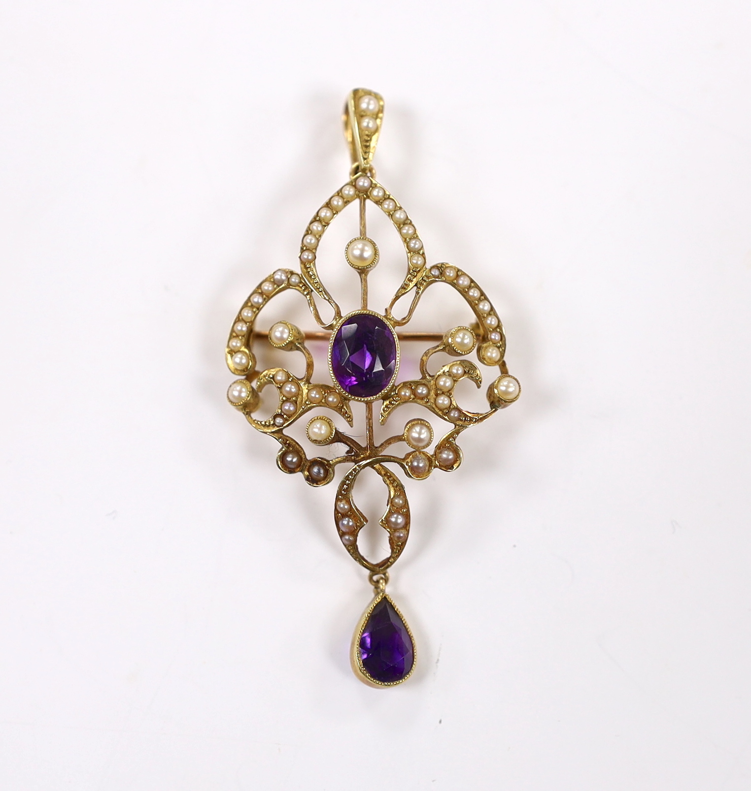 A late Victorian 15ct, amethyst and seed pearl cluster set drop pendant brooch, 55mm, gross weight 5.6 grams.